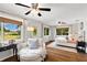 Bright bedroom with hardwood floors, natural light, and comfortable seating area at 9542 Wallien Dr, Brooksville, FL 34601