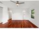 Bright bedroom with hardwood floors, ceiling fan, and natural light at 9542 Wallien Dr, Brooksville, FL 34601