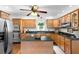 Functional kitchen featuring wooden cabinets, stainless steel appliances, and a practical center island at 9542 Wallien Dr, Brooksville, FL 34601
