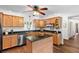 Efficient kitchen features wooden cabinets, stainless steel appliances, and center island at 9542 Wallien Dr, Brooksville, FL 34601