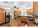 Well-lit kitchen with stainless steel appliances, wooden cabinets, and a functional center island at 9542 Wallien Dr, Brooksville, FL 34601