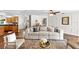 Comfortable living room features a cream colored couch, decorative rug and a glass coffee table at 9542 Wallien Dr, Brooksville, FL 34601