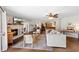 Inviting living room showcasing a stone fireplace, plush seating, and seamless transition to the kitchen and dining area at 9542 Wallien Dr, Brooksville, FL 34601