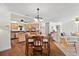 Open-concept living space with hardwood floors, a dining area, and modern furnishings at 9542 Wallien Dr, Brooksville, FL 34601