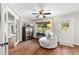 Cozy sitting room with a ceiling fan, hardwood floors, and a peaceful view at 9542 Wallien Dr, Brooksville, FL 34601