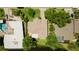 A bird's eye view shows the layout of a home with an adjacent pond and neighboring houses at 3010 Grand View Ave, Clearwater, FL 33759