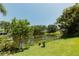 The backyard offers views of a tranquil lake, lush greenery and a tranquil ambiance at 3010 Grand View Ave, Clearwater, FL 33759