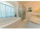 Bathroom with soaking tub and glass shower at 3010 Grand View Ave, Clearwater, FL 33759