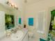 Bright bathroom with a single sink vanity, a mirror, decorative towels, and a shower with a waterfall-themed curtain at 3010 Grand View Ave, Clearwater, FL 33759