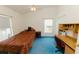 Bedroom featuring a ceiling fan, desk and large bed at 3010 Grand View Ave, Clearwater, FL 33759