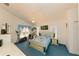 Bedroom with blue carpet, ensuite bathroom, and ceiling fan at 3010 Grand View Ave, Clearwater, FL 33759