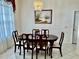 Dining room with dark wood table and chairs and large window at 3010 Grand View Ave, Clearwater, FL 33759