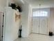 Bright entryway featuring elegant double doors, tile flooring, and decorative architectural details at 3010 Grand View Ave, Clearwater, FL 33759