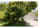 Charming home with lush landscaping in the front yard, adding to its curb appeal at 3010 Grand View Ave, Clearwater, FL 33759