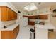 Bright kitchen features light countertops, wood cabinetry, a skylight, and an open layout at 3010 Grand View Ave, Clearwater, FL 33759