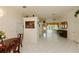 Bright living room with white tile flooring, view to the sunroom, and elegant decor at 3010 Grand View Ave, Clearwater, FL 33759