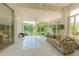 Sunroom with views of the pond, white tile floors, and natural light at 3010 Grand View Ave, Clearwater, FL 33759