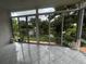 The sunroom features sliding glass doors that provide views of the lake, and a tiled floor at 3010 Grand View Ave, Clearwater, FL 33759