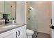 Modern bathroom with black fixtures, grey counters, and a glass shower with built-in niche at 4111 W Swann Ave, Tampa, FL 33609