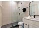 Bathroom features sleek black hardware, frameless glass shower and neutral tile at 4111 W Swann Ave, Tampa, FL 33609