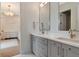 Bathroom featuring a double sink vanity, white countertops, and modern fixtures at 4111 W Swann Ave, Tampa, FL 33609