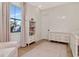 Light-filled Bedroom with hardwood floors, a changing table, a crib and soft hues at 4111 W Swann Ave, Tampa, FL 33609
