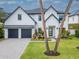 Elegant two-story home with a paved driveway, a two-car garage, and manicured landscaping at 4111 W Swann Ave, Tampa, FL 33609