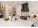 Bright kitchen features white cabinets, stainless steel appliances, and a marble island at 4111 W Swann Ave, Tampa, FL 33609