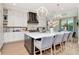 Spacious kitchen with white cabinets, stainless steel appliances, and a statement hood at 4111 W Swann Ave, Tampa, FL 33609
