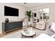 Living room with neutral tones, modern decor, large TV, and decorative lighting at 4111 W Swann Ave, Tampa, FL 33609
