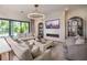 Cozy living room featuring a modern fireplace, plush seating, and an elegant chandelier at 4111 W Swann Ave, Tampa, FL 33609