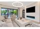 Elegant living room boasts a modern fireplace, plush seating and backyard views at 4111 W Swann Ave, Tampa, FL 33609