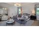 Serene main bedroom with a sitting area, soft colors, and elegant lighting at 4111 W Swann Ave, Tampa, FL 33609