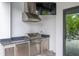 Outdoor kitchen with stainless steel appliances, perfect for entertaining and outdoor dining at 4111 W Swann Ave, Tampa, FL 33609