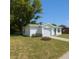 Charming one-story home with a well-maintained lawn and a one-car garage, under a clear blue sky at 10031 Cherry Creek Ln, Port Richey, FL 34668