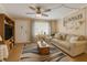 Inviting living room featuring a comfortable sofa, stylish rug, and natural light from a window at 10031 Cherry Creek Ln, Port Richey, FL 34668
