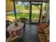 Cozy sunroom featuring tile floors, comfortable seating and natural light at 10031 Cherry Creek Ln, Port Richey, FL 34668