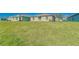 Large backyard with lush green grass and other homes in the background at 10245 Shady Preserve Dr, Riverview, FL 33578