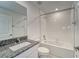 Modern bathroom featuring a granite-topped vanity and a shower-tub combo with tiled walls at 10245 Shady Preserve Dr, Riverview, FL 33578