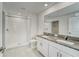Modern bathroom with granite countertop, double sinks, and tiled walk-in shower at 10245 Shady Preserve Dr, Riverview, FL 33578