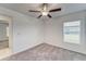 Cozy bedroom featuring neutral carpeting, a ceiling fan, and a bright window at 10245 Shady Preserve Dr, Riverview, FL 33578