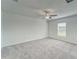 Inviting bedroom featuring neutral carpeting, a ceiling fan, and a bright window at 10245 Shady Preserve Dr, Riverview, FL 33578