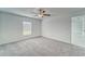 Comfortable bedroom featuring neutral carpeting, a ceiling fan, and a bright window at 10245 Shady Preserve Dr, Riverview, FL 33578