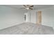 Spacious bedroom featuring neutral carpeting, two doorways, and a ceiling fan at 10245 Shady Preserve Dr, Riverview, FL 33578