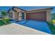 Charming single-story home featuring a manicured lawn and two car garage at 10245 Shady Preserve Dr, Riverview, FL 33578