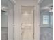 Hallway between two bedrooms and a bathroom featuring updated tile flooring at 10245 Shady Preserve Dr, Riverview, FL 33578
