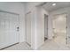 Hallway with tile flooring and views to the front door and full bathroom at 10245 Shady Preserve Dr, Riverview, FL 33578