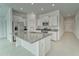 Modern kitchen featuring white cabinets, stainless steel appliances, and a granite island at 10245 Shady Preserve Dr, Riverview, FL 33578