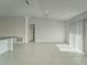 Bright living room with tile flooring, sliding glass doors, and adjacent breakfast bar at 10245 Shady Preserve Dr, Riverview, FL 33578