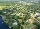 An aerial view of homes nestled amongst lush foliage and lake at 10504 Echo Lake Dr, Odessa, FL 33556